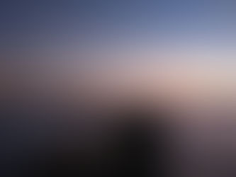 oil tanker navigating the Strait of Hormuz at sunset showing global shipping route