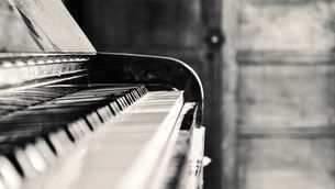 A piano sits ready for live piano music at a restaurant or event