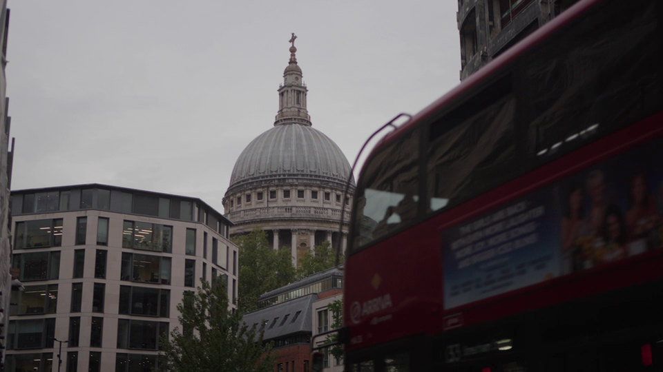 Thumbnail image from a video promoting an Orion Health UK conference event, showcasing the iconic dome of St. Paul's Cathedral in London, framed by modern and under-construction buildings and a red London bus on the right.