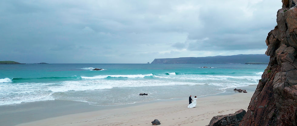 Couple walking on a Scottish beach during their elopement, filmed by CW Wedding Films