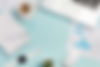 overhead-view-office-desk-with-stationeries-laptop-mouse-smart-watch-blue-backdrop (1).jpg