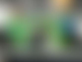 Three people with Coastal Sun pose and smile while holding a medal on stage with a green "THE GROW HUB" backdrop at MJBizCon.