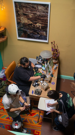 Carlos, NorCal Canna Bear rolls joints a room in Blazin' Better Oakland venue