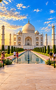 Taj Mahal during sunset with reflecting pool and tourists