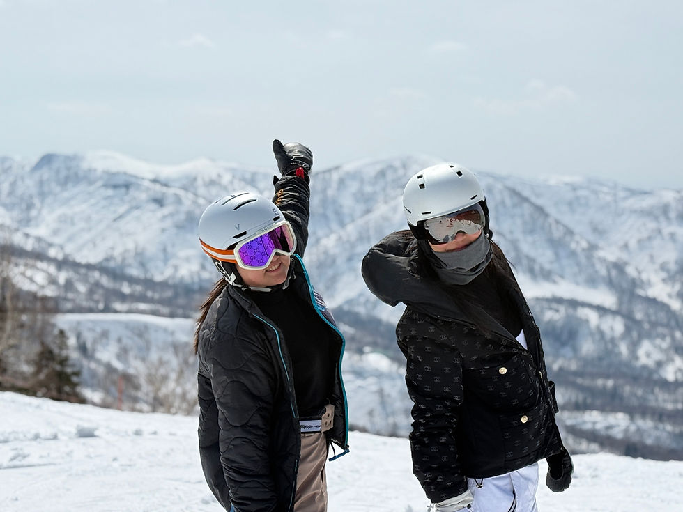 Two snowboarders posing together at Kiroro Ski Resort in Hokkaido, Japan – capturing memories during a private lesson with stunning snowy mountain views.