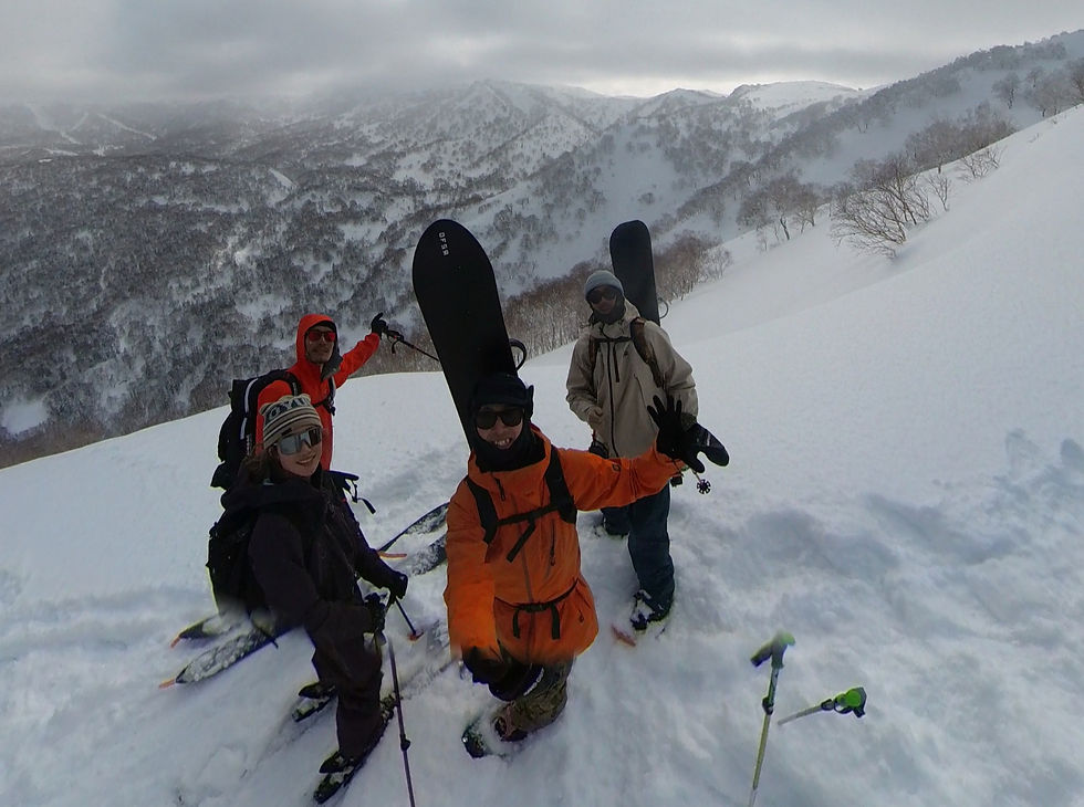 Backcountry snowboarder exploring deep powder terrain in the mountains of Niseko