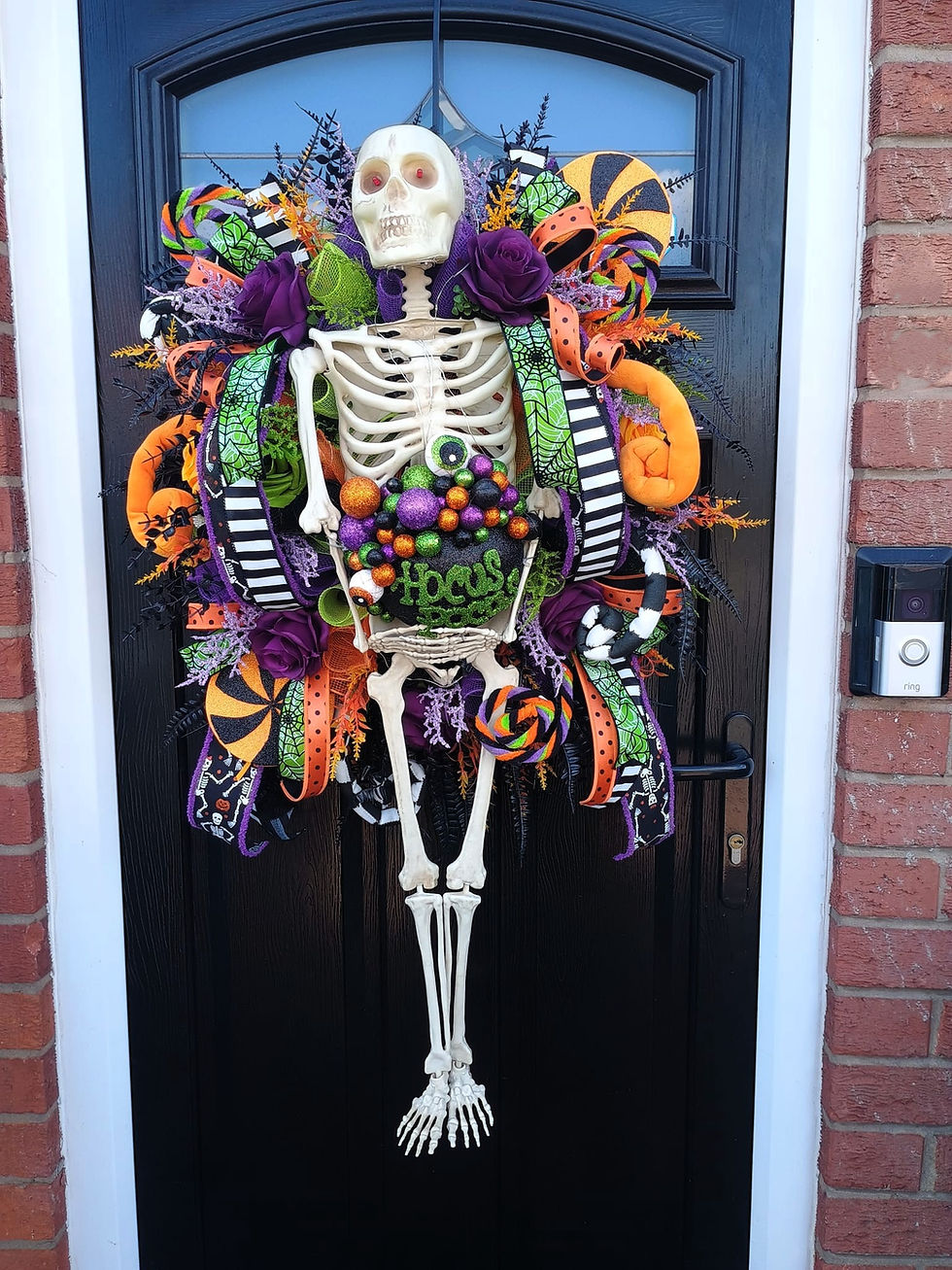 Light up skeleton Hocus Pocus Halloween door wreath with glowing eyes and purple roses - front view