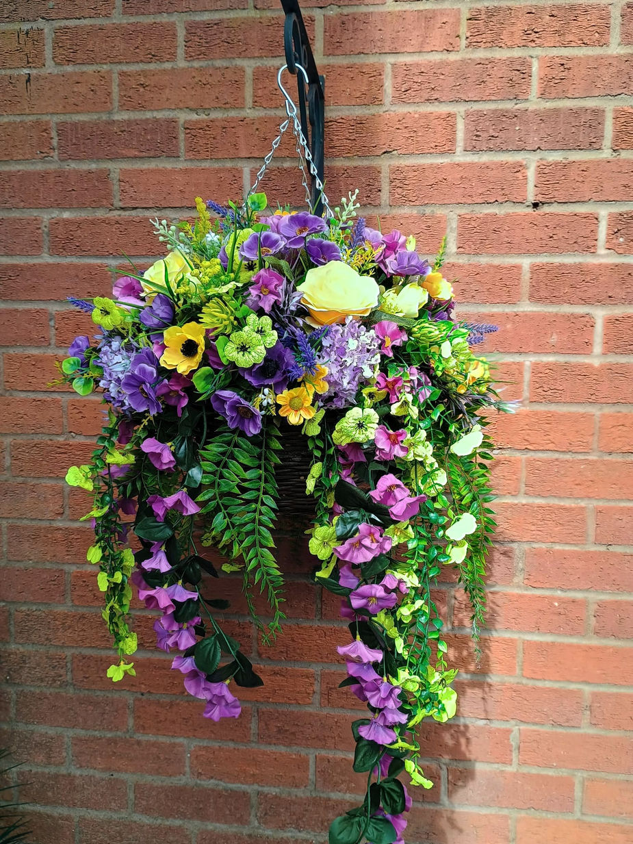 Handcrafted purple and yellow artificial flower hanging basket featuring realistic blooms and premium faux foliage