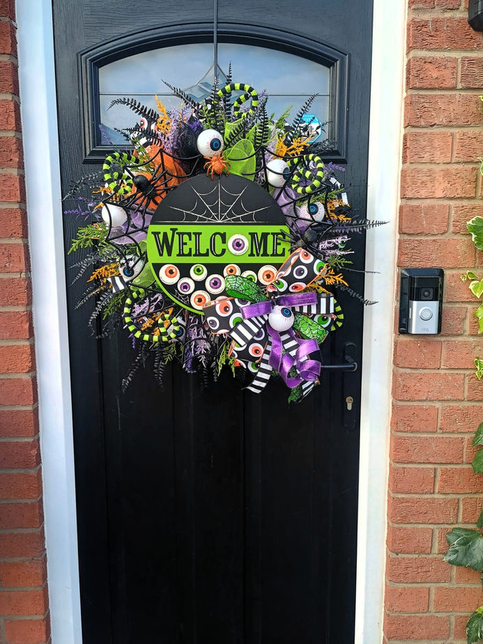 Light up eyeball Halloween door wreath with USA imported metal sign and spooky sound - front view