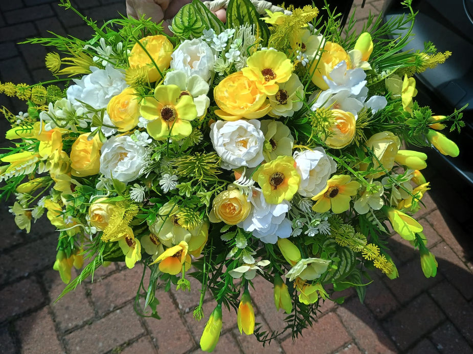 Handmade yellow artificial wall planter with tulips hydrangeas and peonies - close up