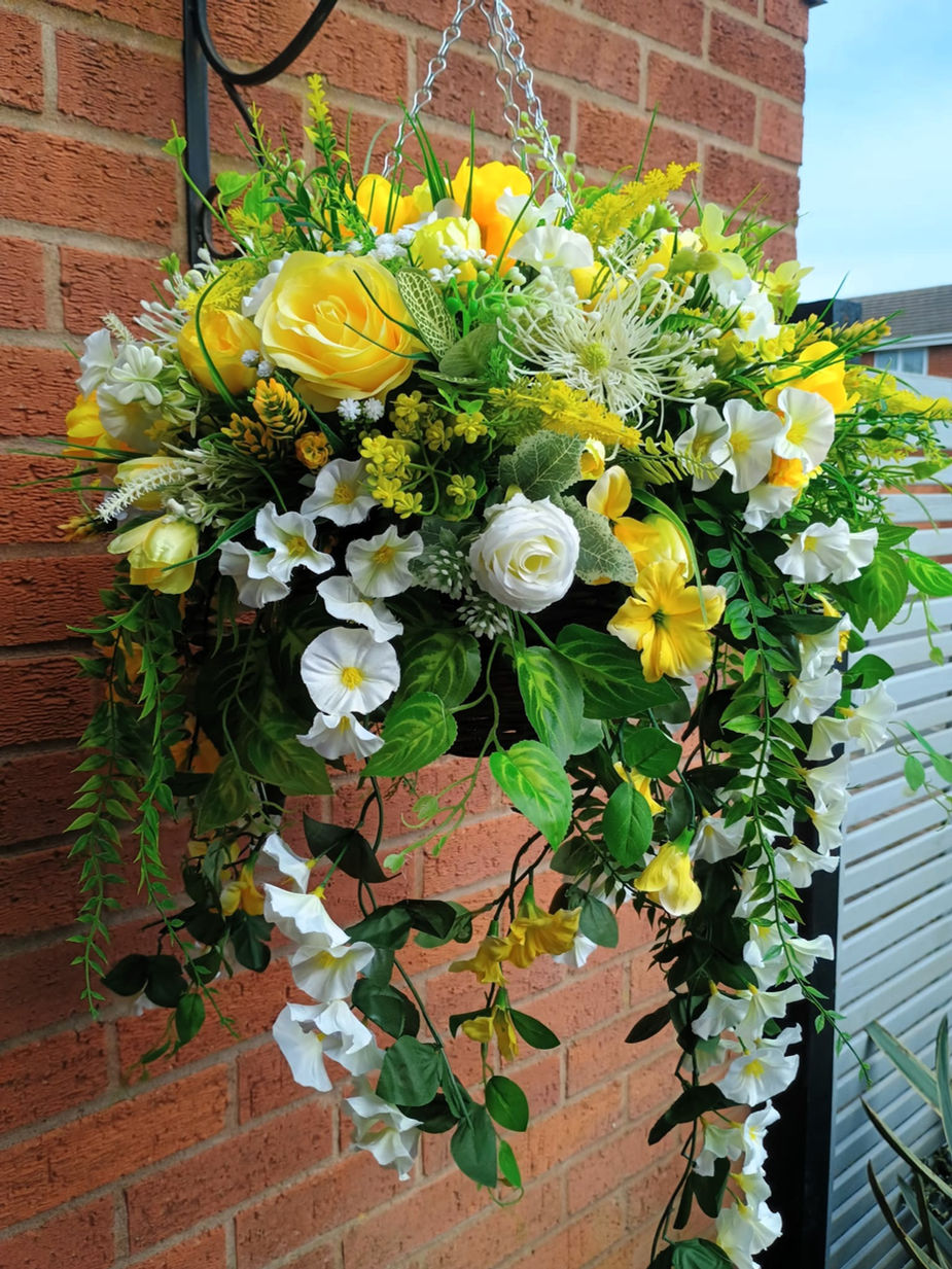Handcrafted yellow and ivory artificial flower hanging basket featuring realistic blooms and premium faux foliage