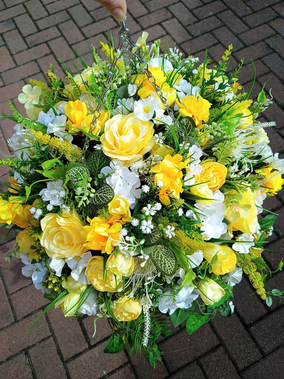 Handcrafted yellow and ivory artificial flower hanging basket featuring realistic blooms and premium faux foliage