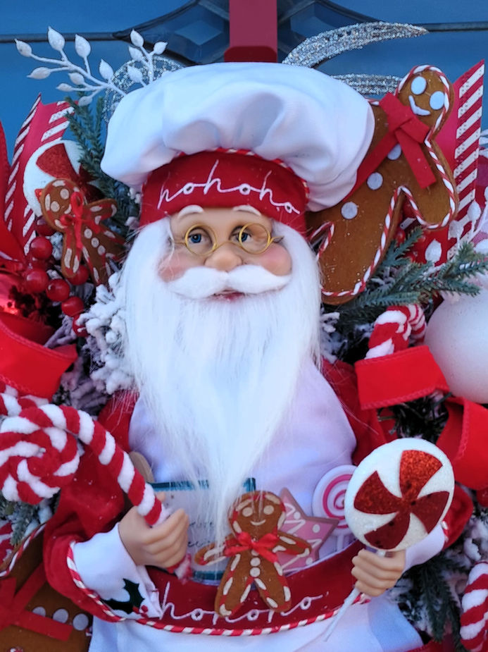Santa Claus in a chef hat with red and white decorations,