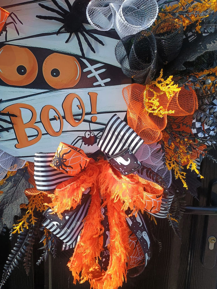 Close up of handmade ghost with coffee cup and pumpkin on Halloween cute ghost wreath UK
