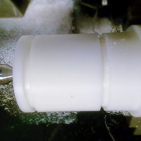 Plastic part, being turned on a lathe. Our Job shop machining services offer plastic parts manufacturing for a large amount of applications and diverse uses. We are expert plastic part machinists able to do small machining jobs and large quantities.