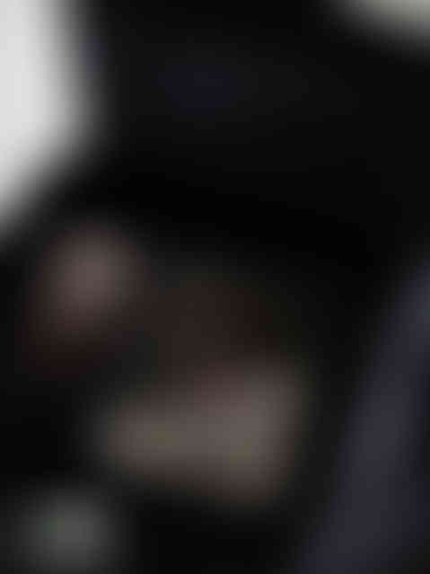 iPhone and iPad mockup on black velvet chair showing responsive design presentation with sleek minimal black aesthetic for Af