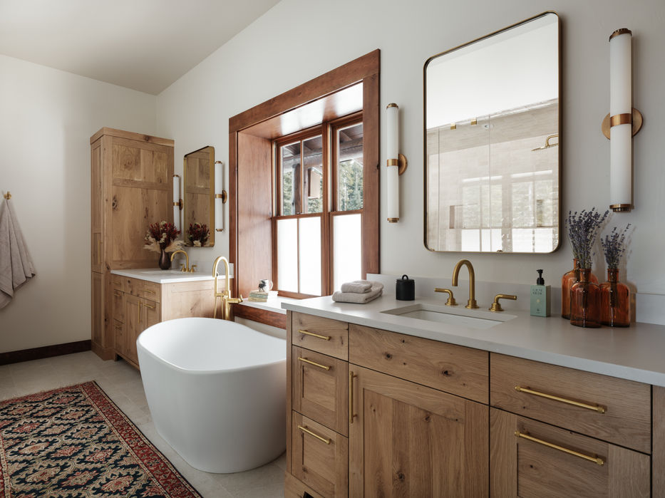 Lazy G Remodel — primary bathroom with freestanding soaking tub, wood vanity, and natural light, Big Sky, Montana, Red Tree Design