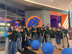 Team members standing together and smiling for a group picture