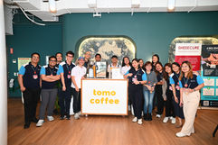 Team members standing together while smiling