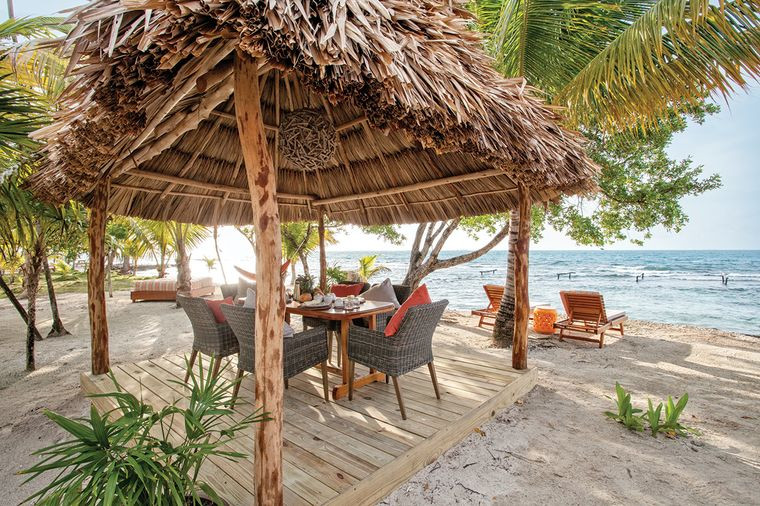 Beach palapa with table and chairs, and view of the beach