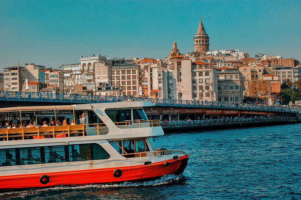 Passengers aboard a ferry near Galata Bridge, with Galata Tower rising above Istanbul’s waterfront.