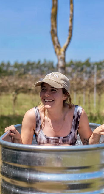 Guest enjoying a cold plunge during a Wine Down Sunday wellness event at Saffron Grange Vineyard with Revivo Sauna and OutTrain.