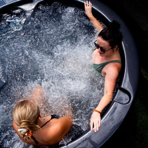 Relaxing in a traditional wood-fired hot tub at Abbots Ripton Estate