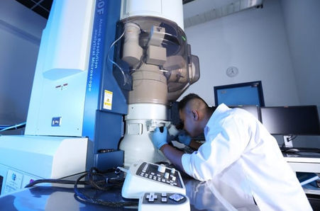 A scientist using a high-precision electron microscope