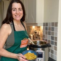 Woman wearing apron cooking instant pot