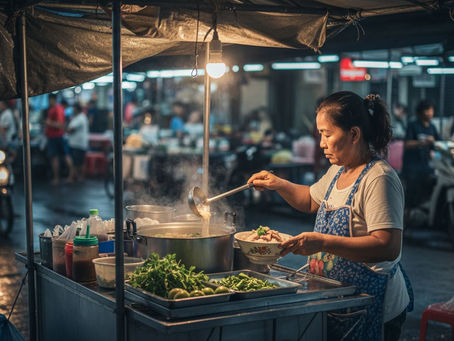 Thai vendor preparing noodles at street market
