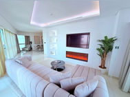 Fully furnished 2-bedroom apartment interior at Paramount Tower, Business Bay showcasing modern living room design