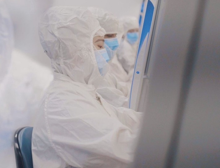 Manufacturing technicians, wearing standard PPE, focusing on their daily tasks in the BSC.