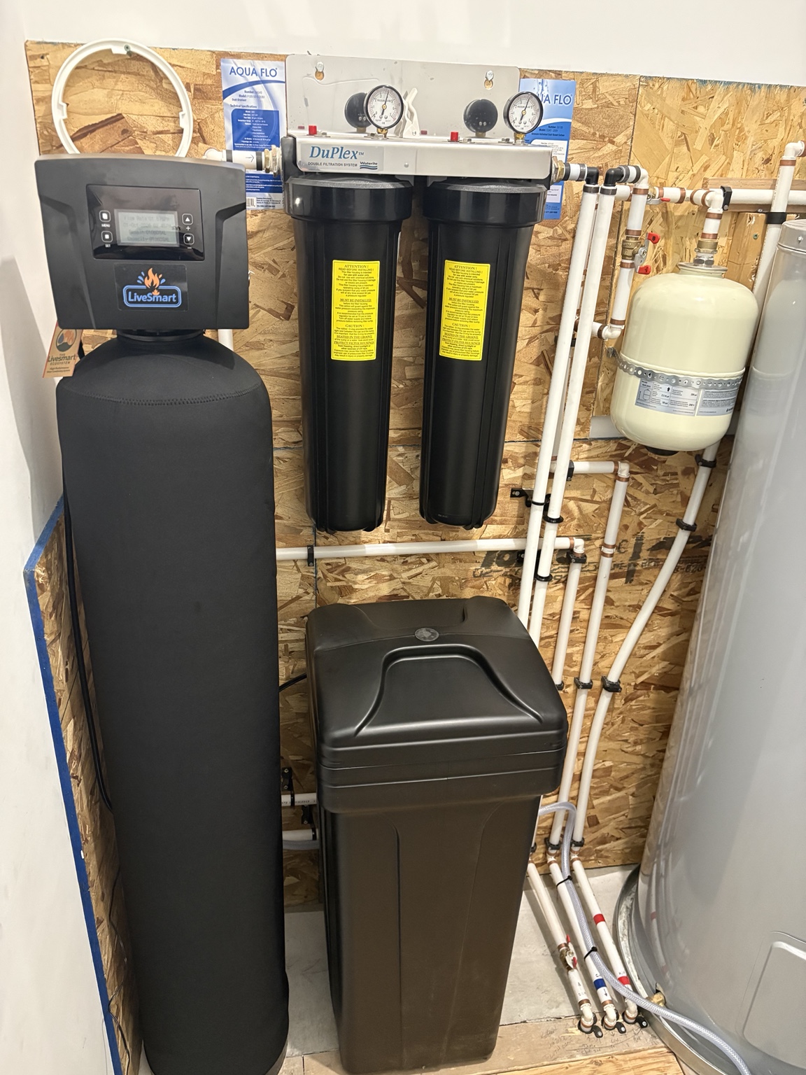 LiveSmart softener, brine tank and twin filter housings in an Anarchist Mountain well-water installation