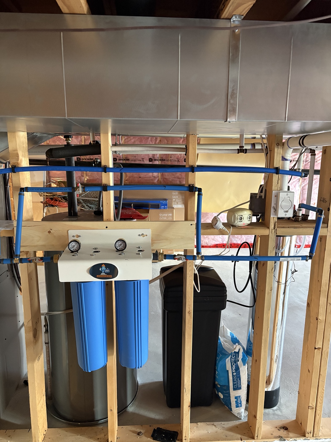 Two blue prefilter housings mounted with pressure gauges