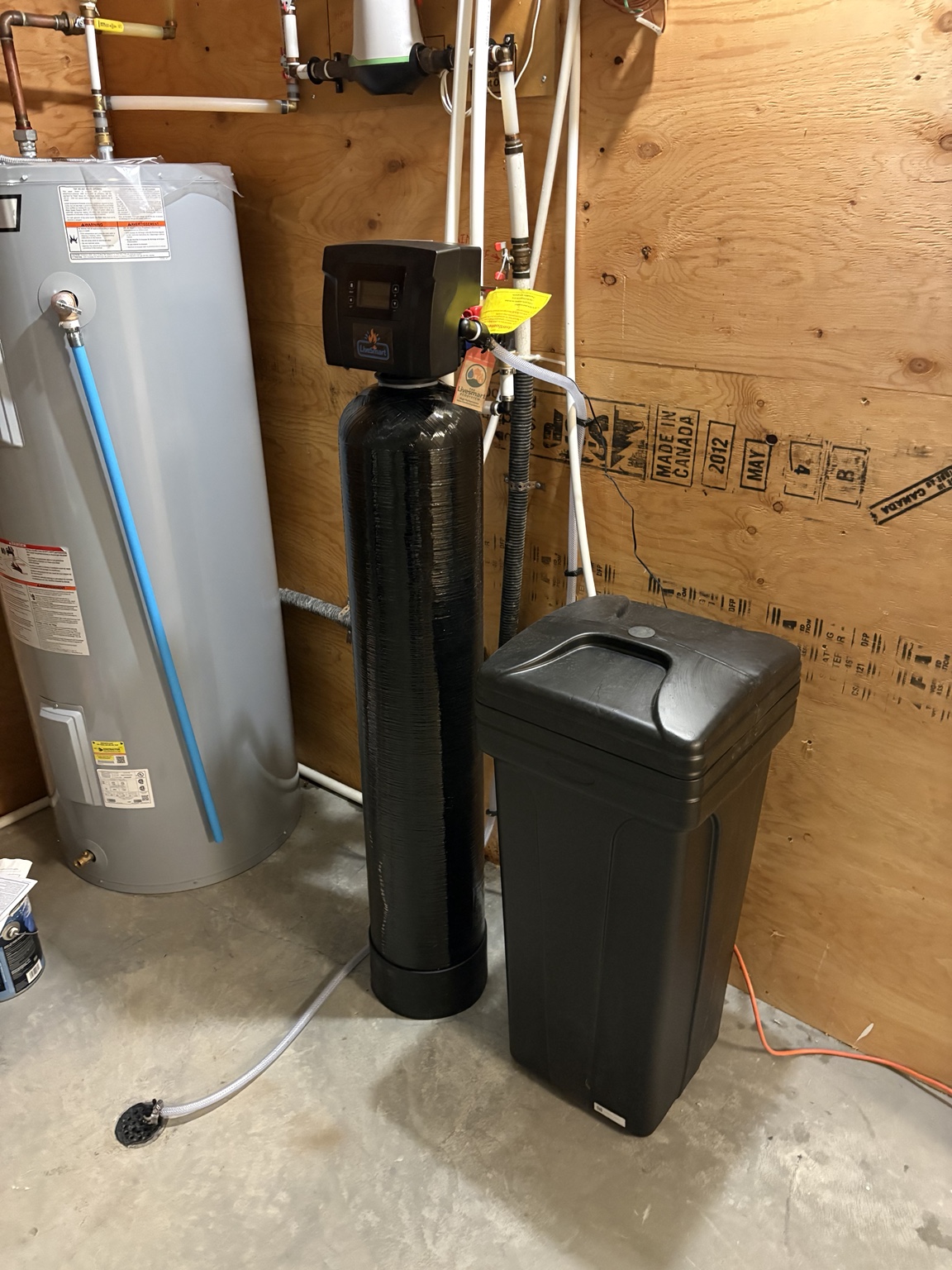 LiveSmart water-treatment equipment and brine tank in a utility room