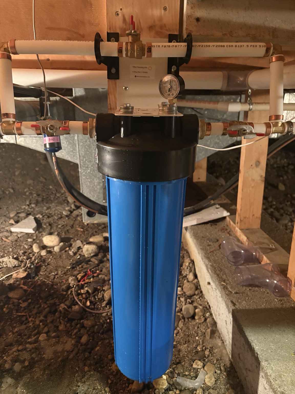 Blue filter housing with a pressure gauge and bypass in a crawlspace