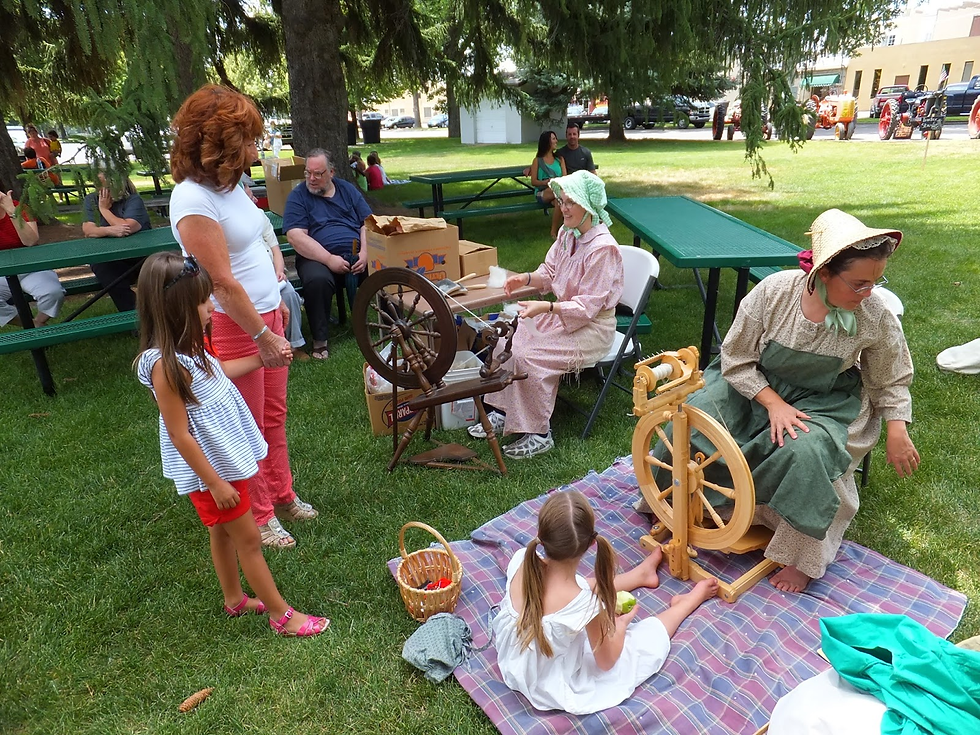 Melissa Draper and Julia Seare demonstrate the heritage art of making thread on spinning wheels.