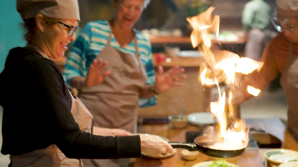 Visitors participating in a Vietnamese cooking experience during a cultural tour in Vietnam.