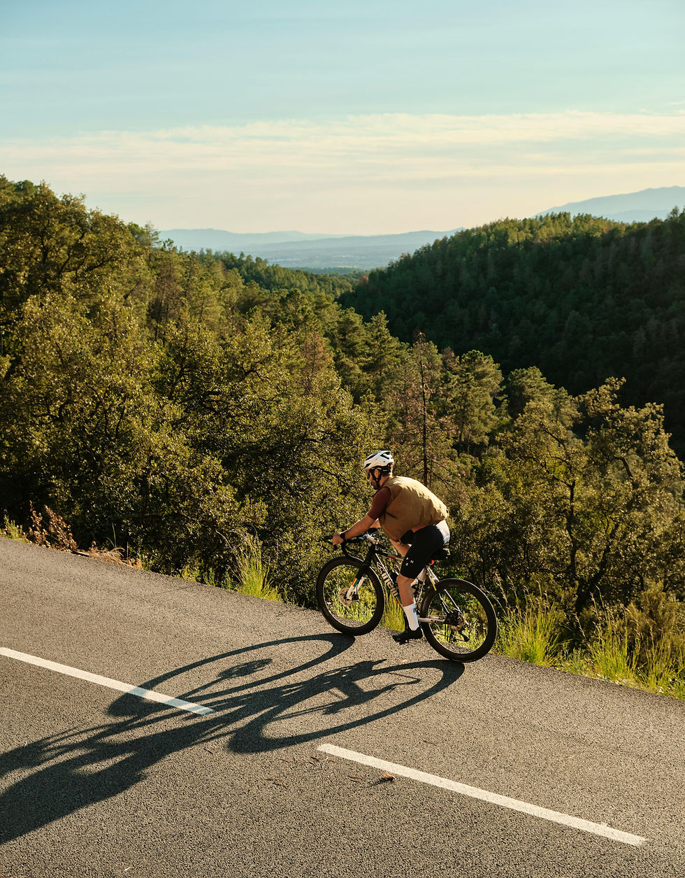 Cyclist on scenic Catalonia route near Vall Amagada del Molí boutique hotel with bike-friendly facilities