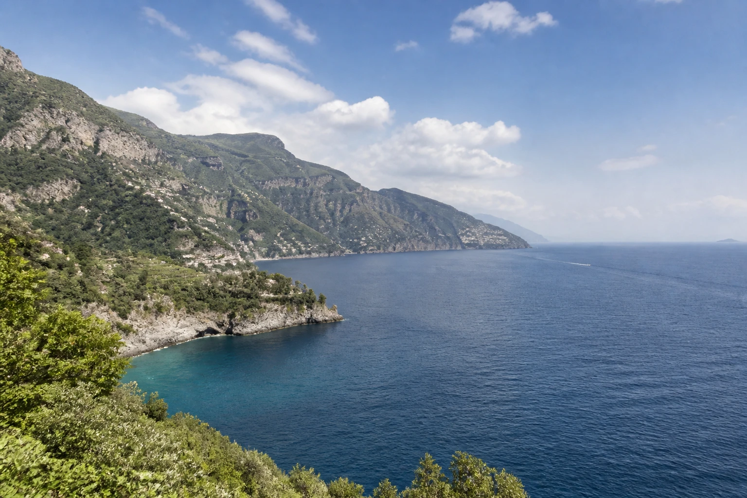 Representative coastal destination view: Amalfi Coast, Italy; coastline and regional vegetation, not an exact landmark photograph.