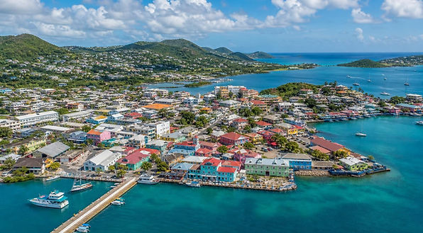 Aerial view of St. John's harbor, colorful buildings and blue water in Antigua