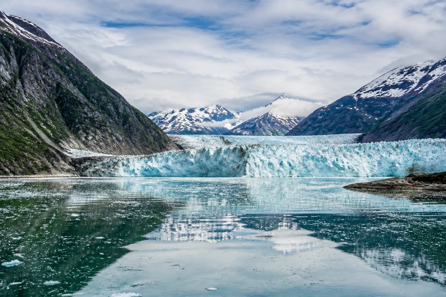 Representative national park destination view: Glacier Bay National Park, United States; tidewater glacier and cold bay water, not an exact landmark photograph.
