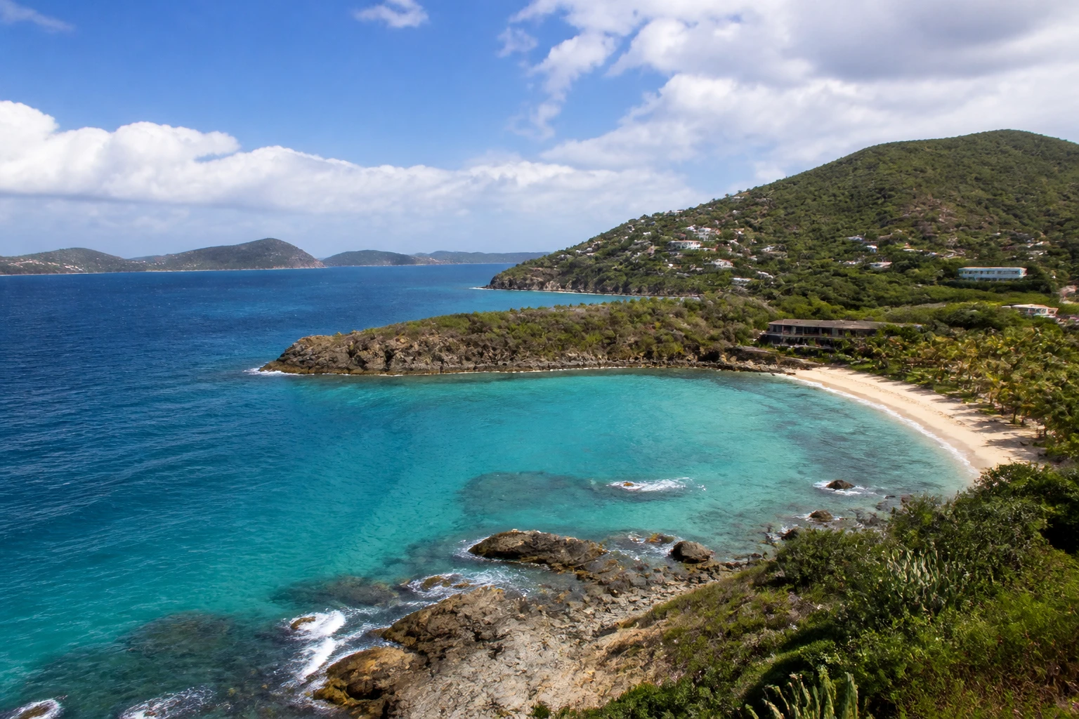 Representative island destination view: Saint Thomas, U.S. Virgin Islands; coastline and regional vegetation, not an exact landmark photograph.