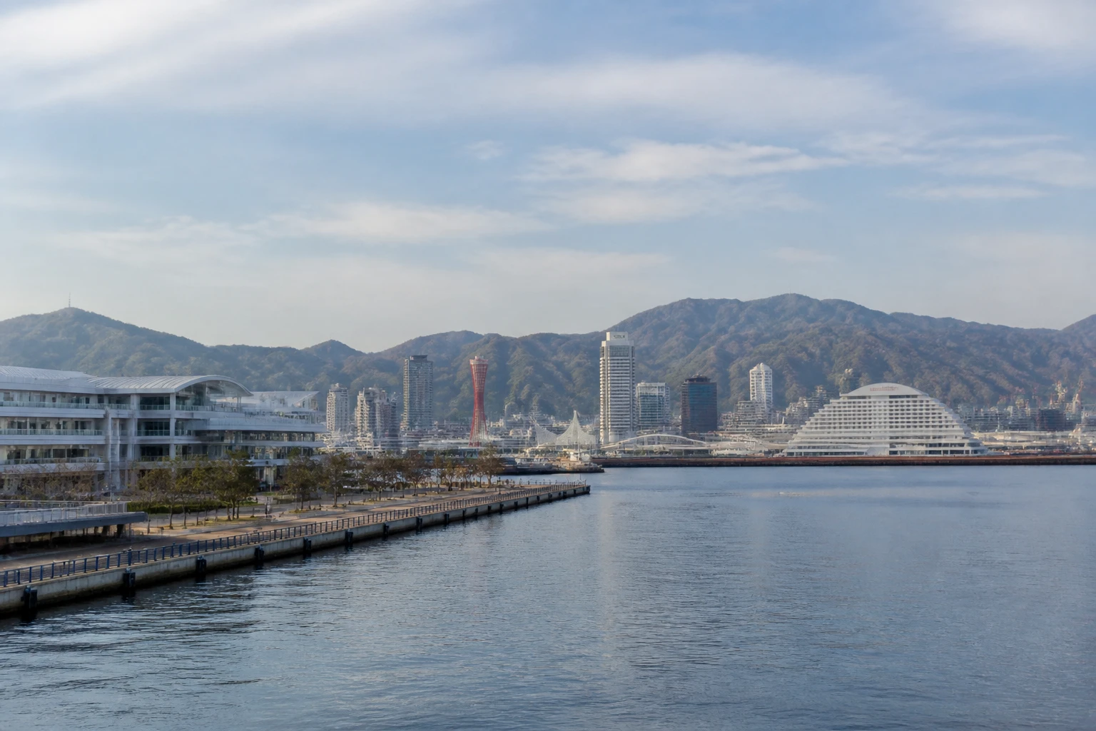 Representative cruise port destination view: Kobe, Japan; passenger waterfront and harbor water, not an exact landmark photograph.