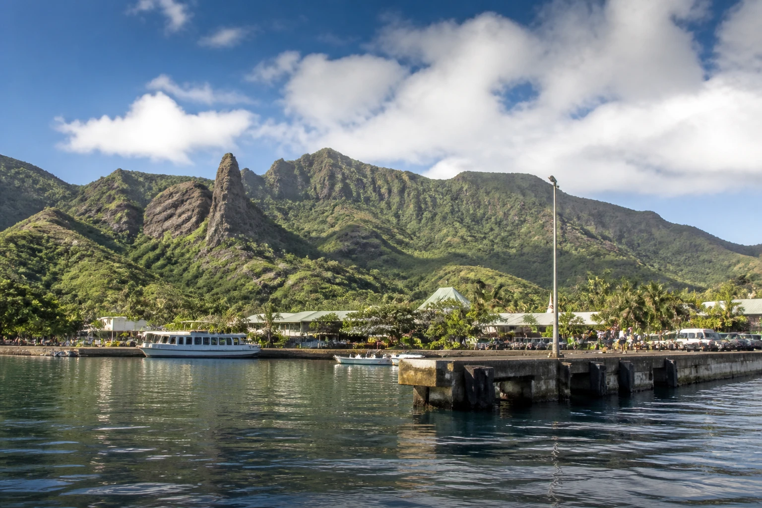 Representative cruise port destination view: Nuku Hiva, French Polynesia; passenger waterfront and harbor water, not an exact landmark photograph.