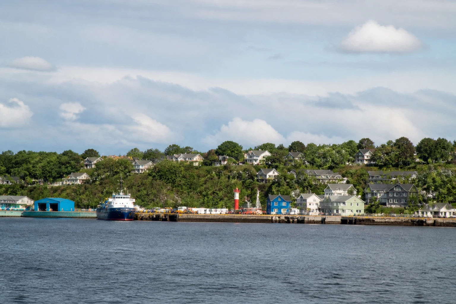 Representative cruise port destination view: Sydney, Canada; passenger waterfront and harbor water, not an exact landmark photograph.