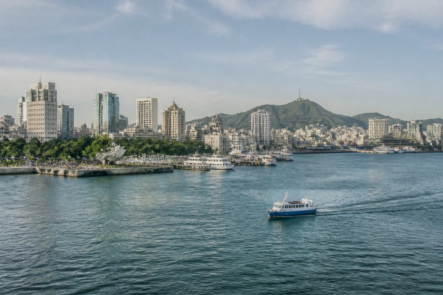 Representative cruise port destination view: Dalian, China; passenger waterfront and harbor water, not an exact landmark photograph.