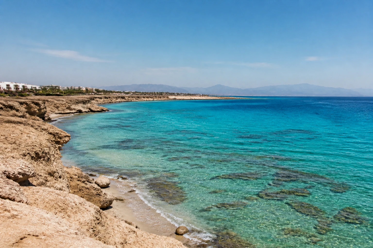 Representative coastal destination view: Hurghada and the Red Sea, Egypt; coastline and regional vegetation, not an exact landmark photograph.
