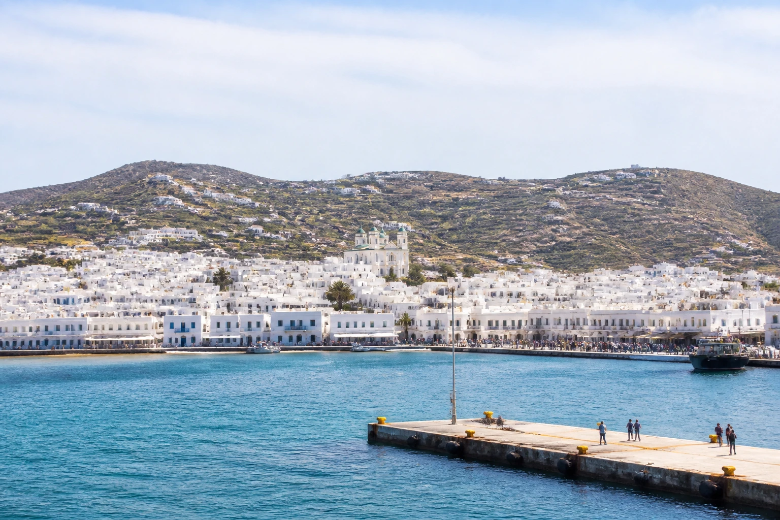 Representative cruise port destination view: Paros, Greece; passenger waterfront and harbor water, not an exact landmark photograph.
