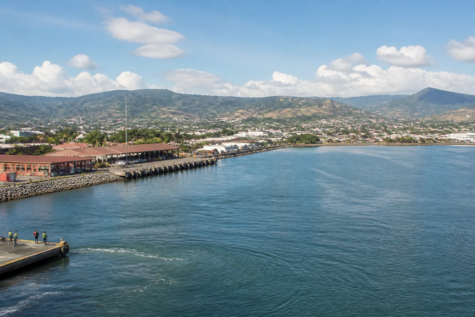 Representative cruise port destination view: Puerto Caldera, Costa Rica; passenger waterfront and harbor water, not an exact landmark photograph.